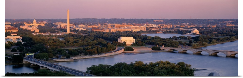 Large panoramic photo art of the major monuments that make up the capitol of the United States at sunrise.