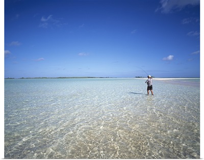 Rear view of a man fishing in the ocean, Tuamotu Archipelago, French Polynesia