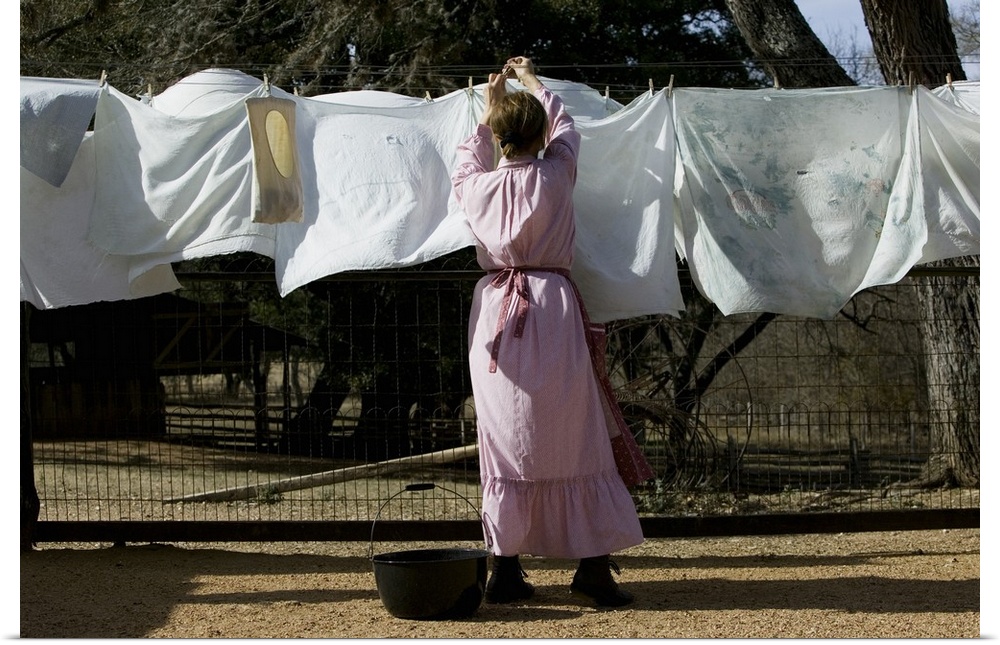 Rear view of a woman drying clothes on a clothesline, Lyndon B. Johnson National Historical Park, Johnson City, Texas