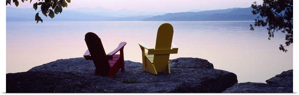 Horizontal photograph on a big canvas of two adirondack chairs sitting at the edge of a rocky cliff, overlooking the calm ...
