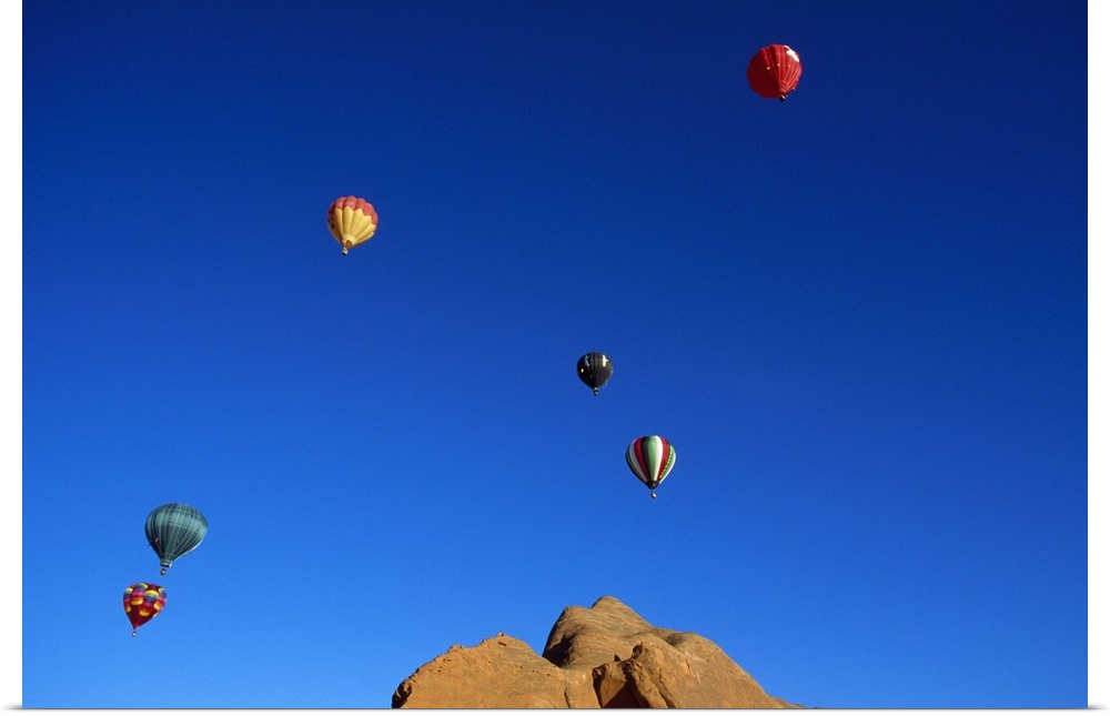 Red rock cliffs, hot air balloons in blue sky, Gallup, New Mexico