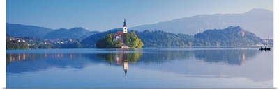 Reflection of mountains and buildings in water, Lake Bled, Slovenia