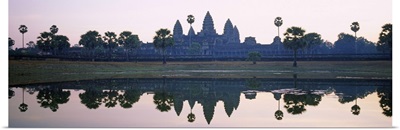 Reflection of temples and palm trees in a lake, Angkor Wat, Cambodia