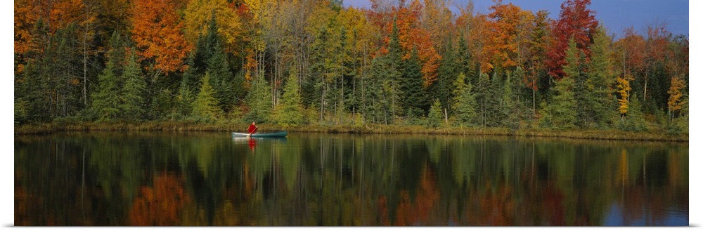A lone canoer on the lake during the fall in Antigo, Wisconsin.