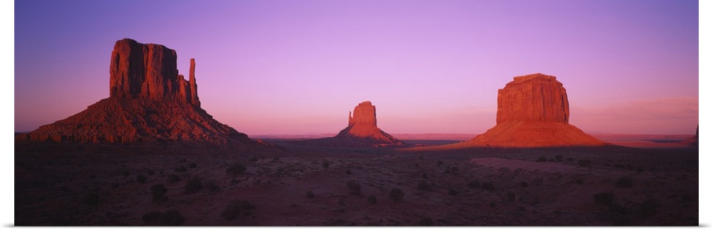 Rock formations on an arid landscape at dusk, Monument Valley, Utah