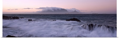 Rocks in the sea with Table Mountain in the background, Bloubergstrand, Table Mountain, Cape Town, Western Cape Province, Republic of South Africa