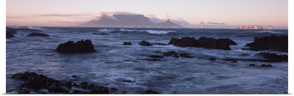 Rocks in the sea with Table Mountain in the background, Bloubergstrand, Table Mountain, Cape Town, Western Cape Province, ...
