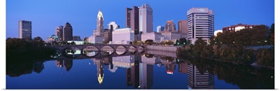 Scioto River and Columbus Ohio skyline, the capital city, at dusk with lights on