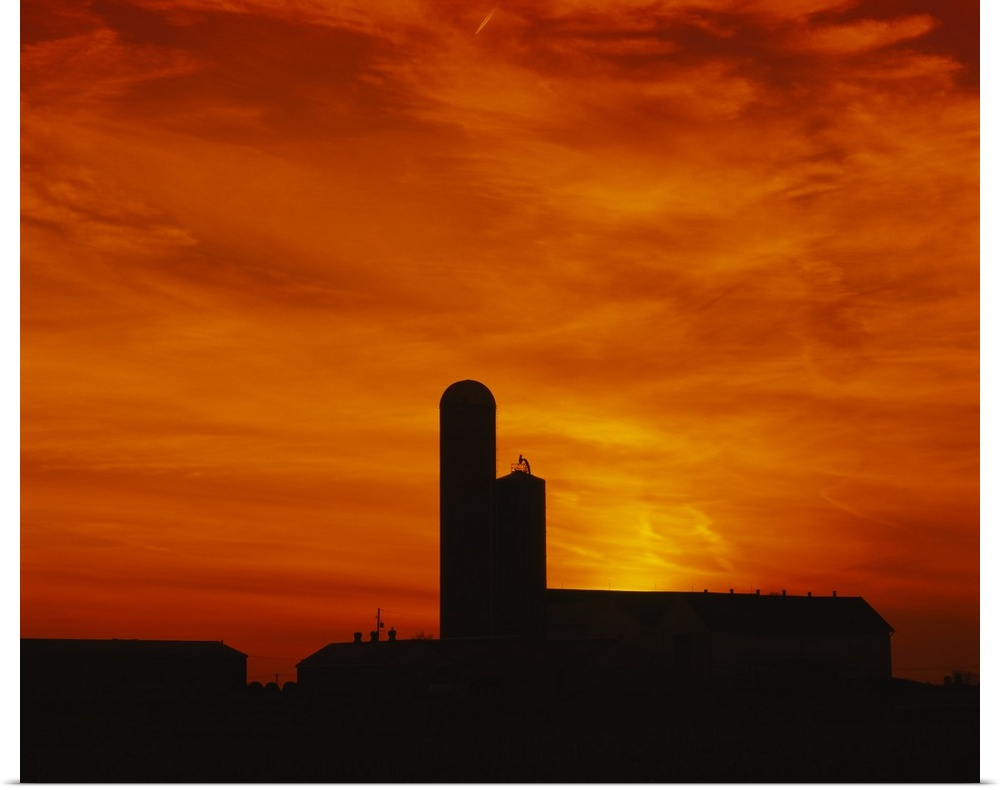 Silhouette of a barn and a silo at sunset, Pennsylvania