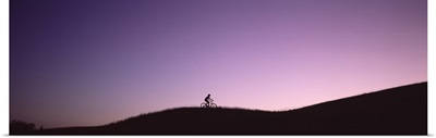 Silhouette of a person mountain biking, Waits River, Vermont