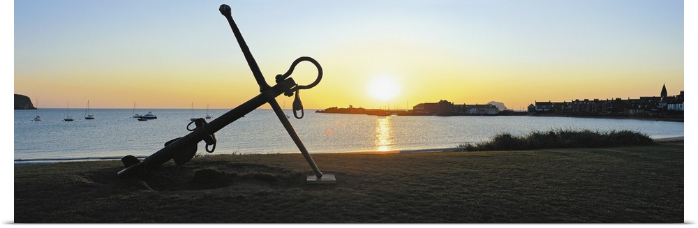 Silhouette of an anchor on the beach at sunrise, North Berwick, East Lothian, Scotland