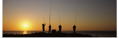 Silhouette of fishermen fishing in river at sunset Scottburgh KwaZulu Natal South Africa