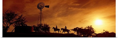 Silhouette of two horse riders at sunset, Hunt, Kerr County, Texas