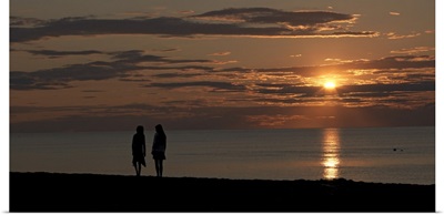 Silhouette of two people on the beach at sunset, Jetties Beach, Nantucket, Massachusetts