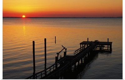 Silhouetted ocean pier at sunrise, Maryland