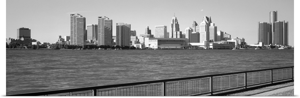 This panoramic photograph is in black and white and taken of the Detroit skyline from across the river that is in front of...