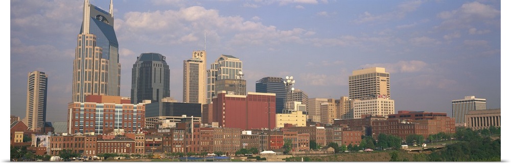 Large horizontal panoramic photograph of the downtown Nashville, Tennesee (TN) skyline with skyscrapers and other buildings.