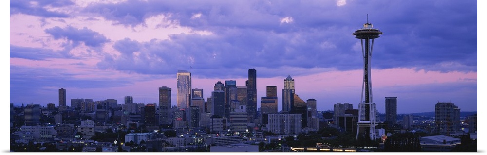 Panoramic cityscape photo of a major Pacific Northwest city with the Space Needle on the right.