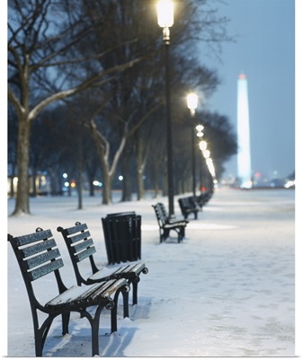 Snow covered benches along a footpath, Washington Monument in background, Washington DC