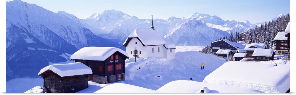Snow Covered Chapel and Chalets Swiss Alps Switzerland