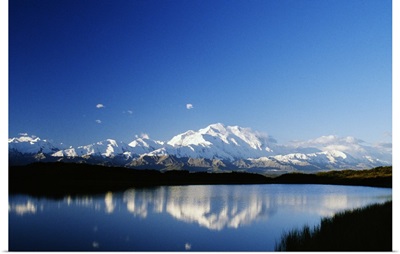 Snow-covered Mount McKinley reflected in lake, blue sky, Denali National Park, Alaska
