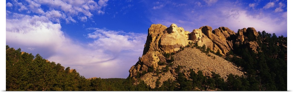 A picture of Mount Rushmore is taken from a distance and has it skewed to the right in this panoramic view.