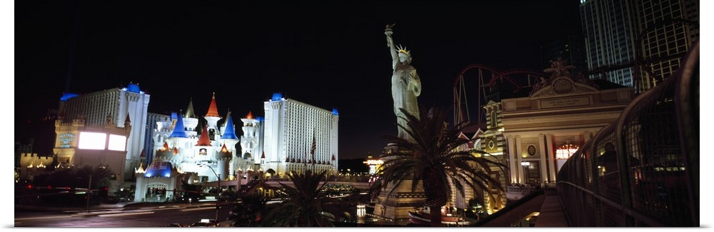 Panoramic photograph of the Las Vegas strip at night, the Statue of Liberty and New York, New York in the foreground, and ...