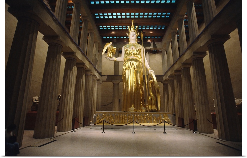A golden statue of Athena stands in an art museum that is a replica of the original Parthenon in Greece.