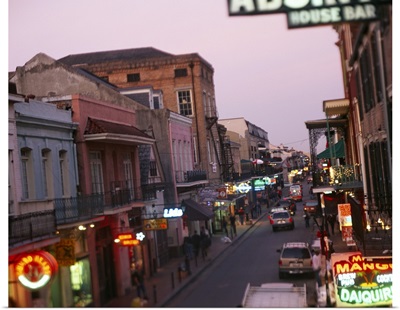 Store signs lit up at dusk, Bourbon Street, New Orleans, LA