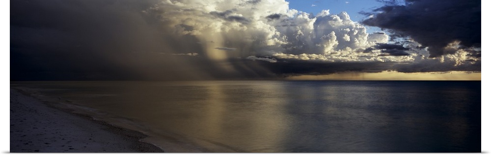 This is a panoramic photograph of clouds accumulating off shore before sunset.