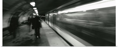 Subway train passing through a subway station, London, England