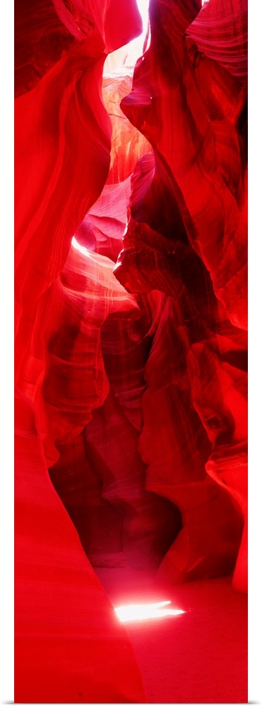 A vertical photograph with vivid colors shows the passage through a narrow canyon.