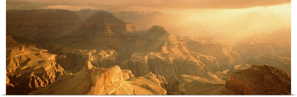 Panoramic photo on canvas of the Grand Canyon bath in warm sunlight from a rising sun.