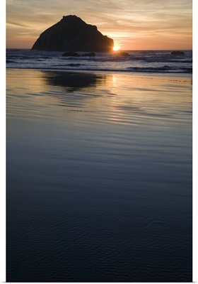 Sunset behind silhouetted sea stack on Bandon Beach, Bandon Beach State Park, Oregon
