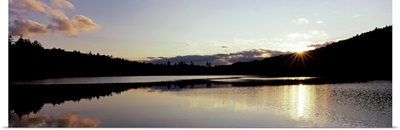Sunset over mountains, Upper Brown Tract Pond, Adirondack Mountains, New York State,
