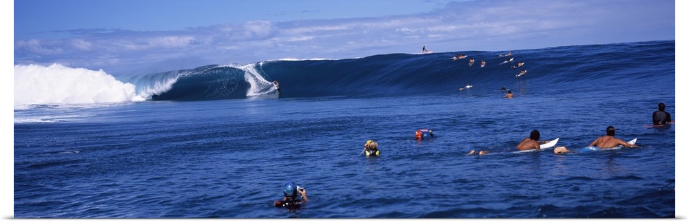 Surfers in the sea, Tahiti, French Polynesia
