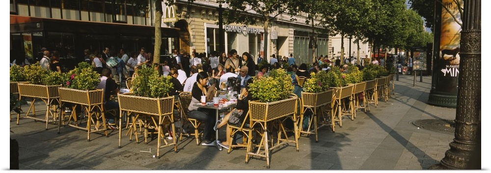 Tourists sitting at a sidewalk cafe, Avenue Des Champs-Elysees, Paris, France
