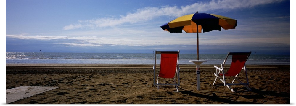 Two empty chairs under a beach umbrella, Lignano Sabbiadoro, Italy