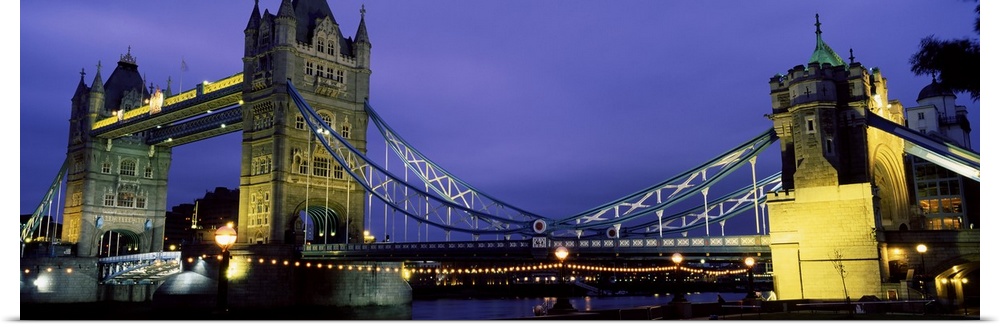 Panorama of London's iconic Tower Bridge at night.