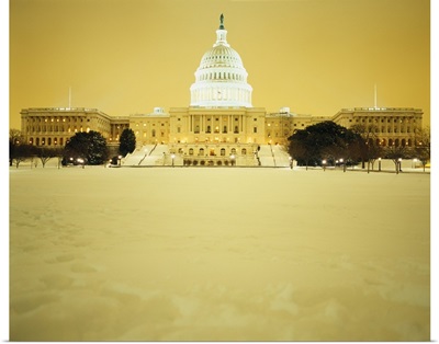 US Capitol Building illuminated at night with snow, Washington DC
