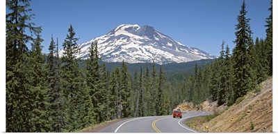 Vehicle moving on a road with South Sister Mountain in background, Oregon