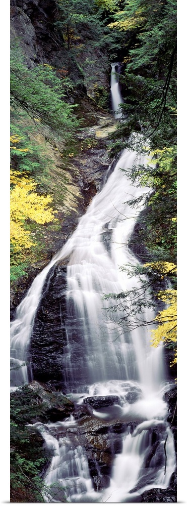 Vertical, large photograph of Moss Glen Falls surrounded by rocky terrain and fall foliage, in the CC Putnam State Forest,...