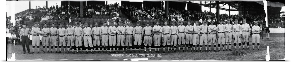 Giant, horizontal photograph of the 1913 Washington baseball team standing in front of bleachers that are partially full o...