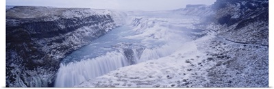 Water flowing through snow covered mountains, Gullfoss Falls, Vesturland, Iceland