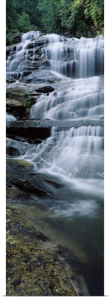 Vertical panoramic of a series of smaller waterfalls making up a large stairway of water pouring down rocks in Nantahala N...