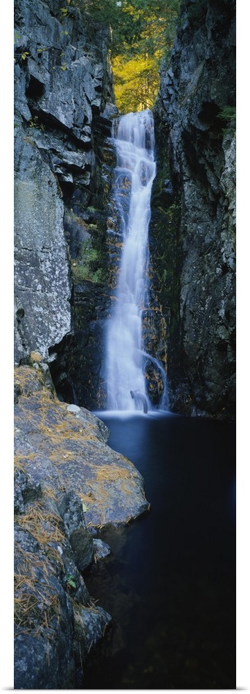 Vertical photograph on a giant canvas of a large waterfall surrounded by the rocky edges of a forest in Moultonborough, Ne...