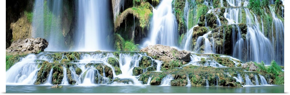 Serene wall art for the home or office a panoramic photograph of the bottom of a rocky waterfall with multiple cascades.