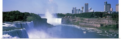 Waterfall with city skyline in the background, Niagara Falls, Ontario, Canada