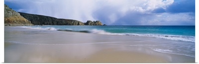 Waves breaking on the beach Logan Rock Porthcurno Bay Cornwall England