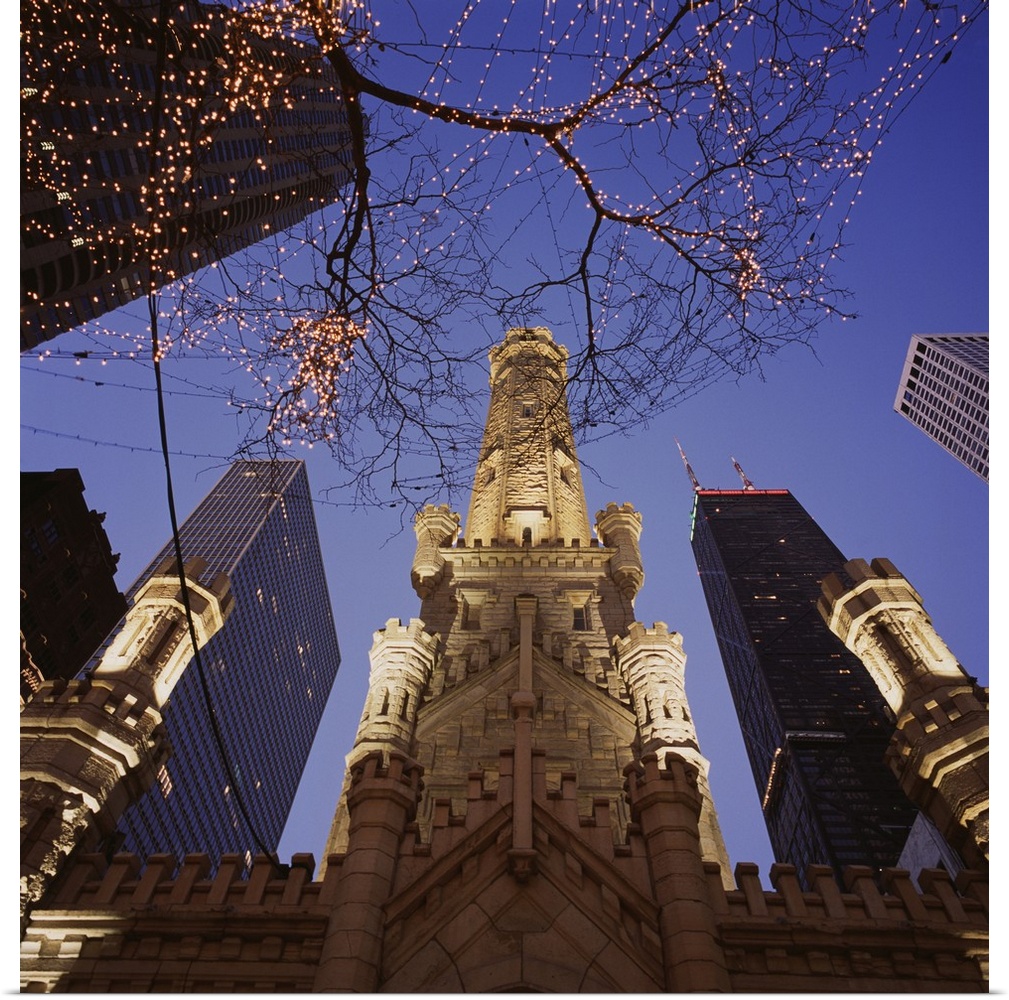 Huge photograph taken from the ground looking up at a tree filled with lights sitting in front of the Chicago Avenue Pumpi...